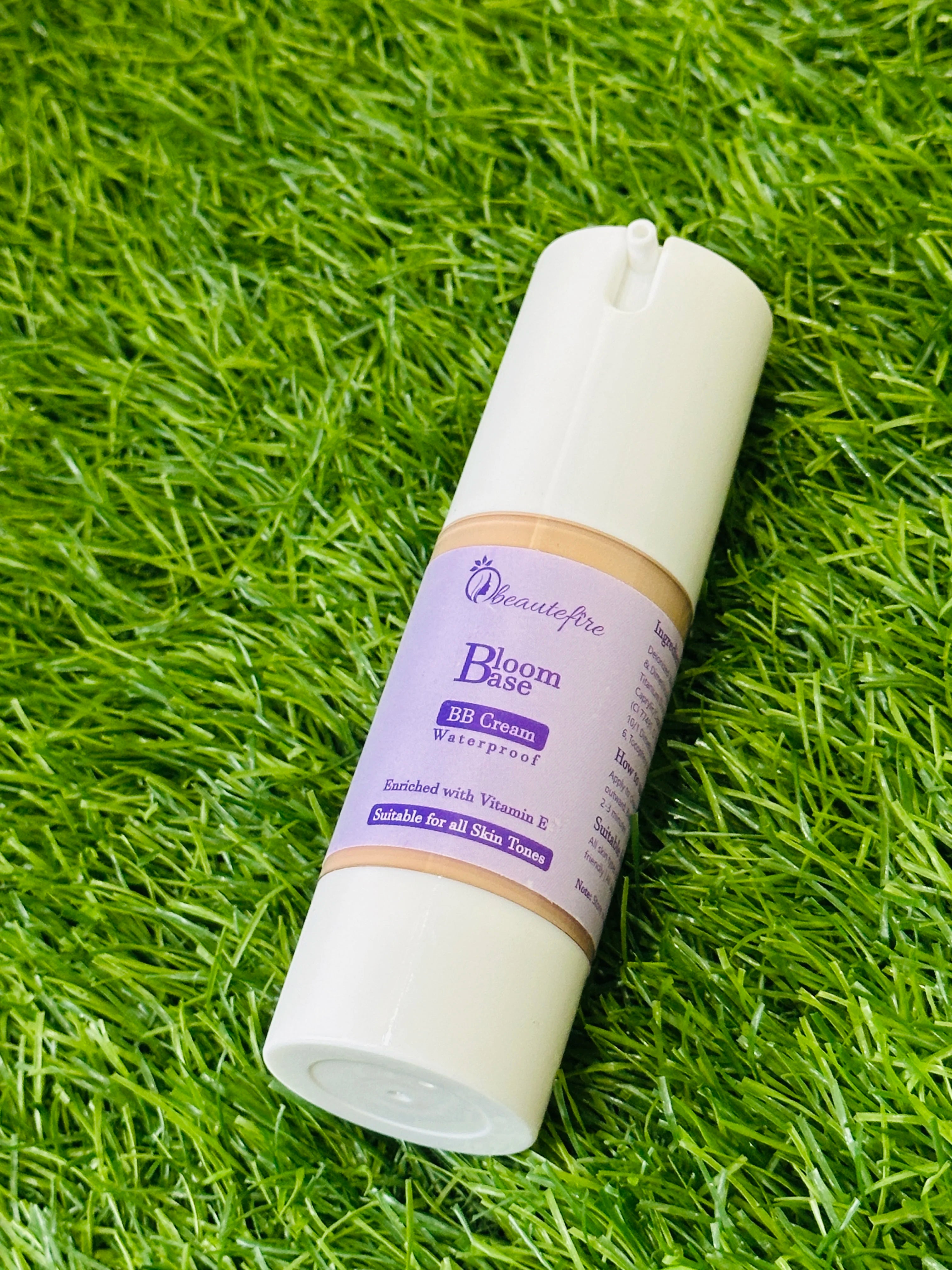 Beautefire Bloom Base BB Cream on grass ā natural flat lay highlighting radiant, breathable skincare-makeup blend.
