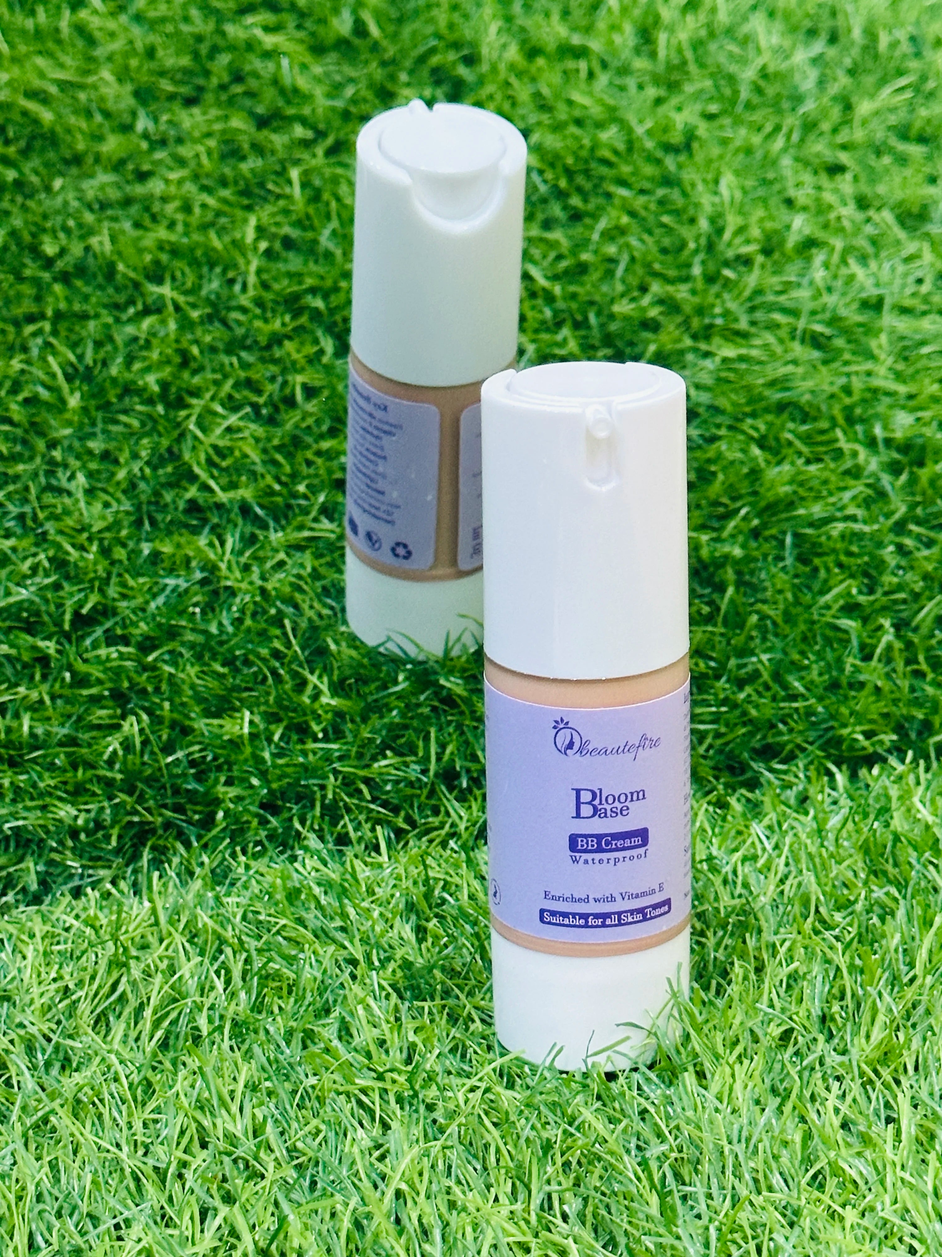 Beautefire Bloom Base BB Cream on grass and mirror ā natural flat lay highlighting radiant, breathable skincare-makeup blend.