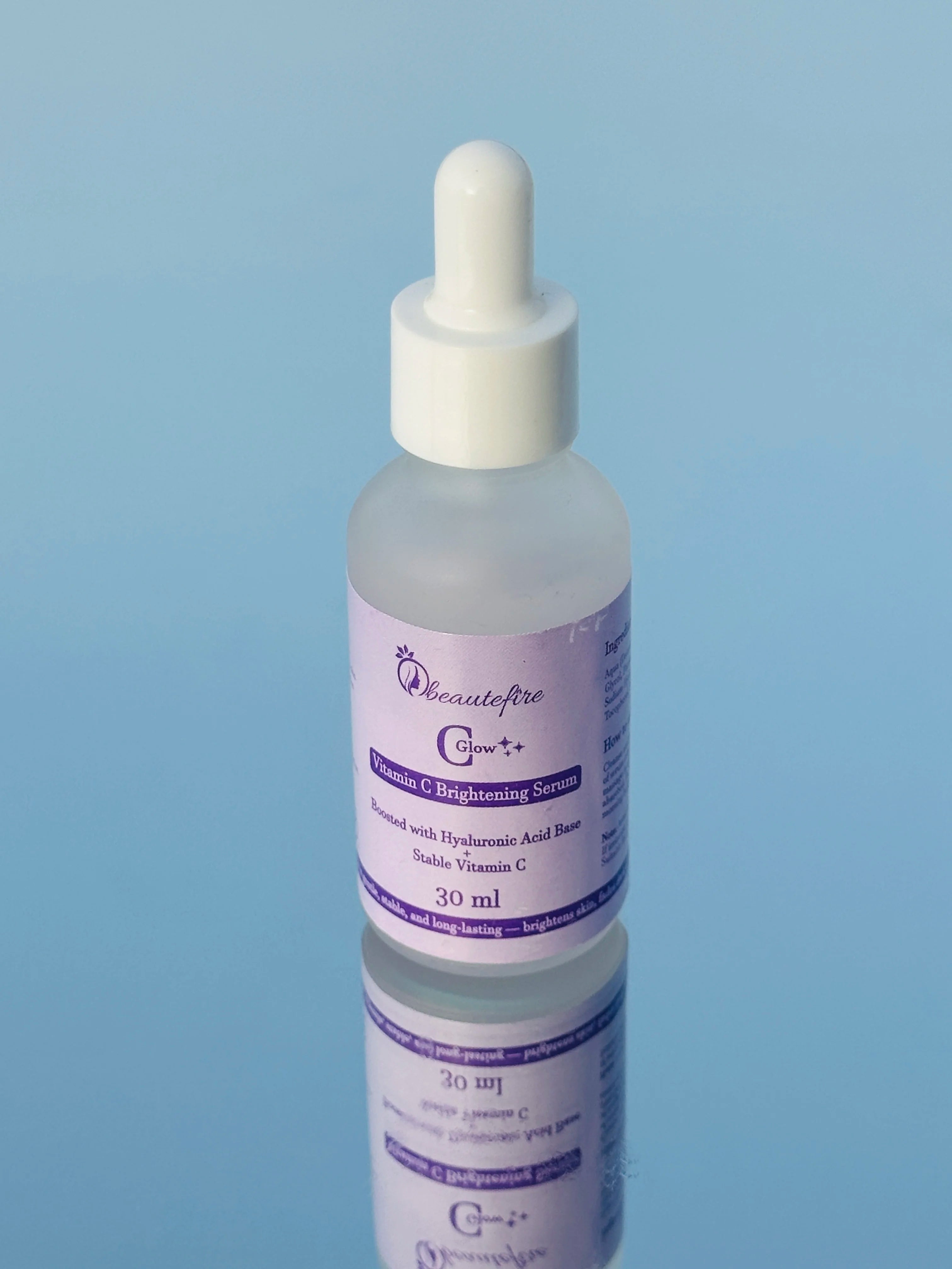 Beautefire C Glow Serum placed on light blue mirror ā natural light capture of hydrating, glow-boosting Vitamin C serum.