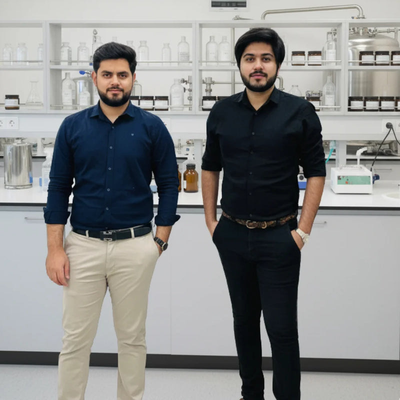 Beautefire founders in skincare lab with cosmetic bottles and equipment — symbolizing science-backed, luxury skincare formulation.