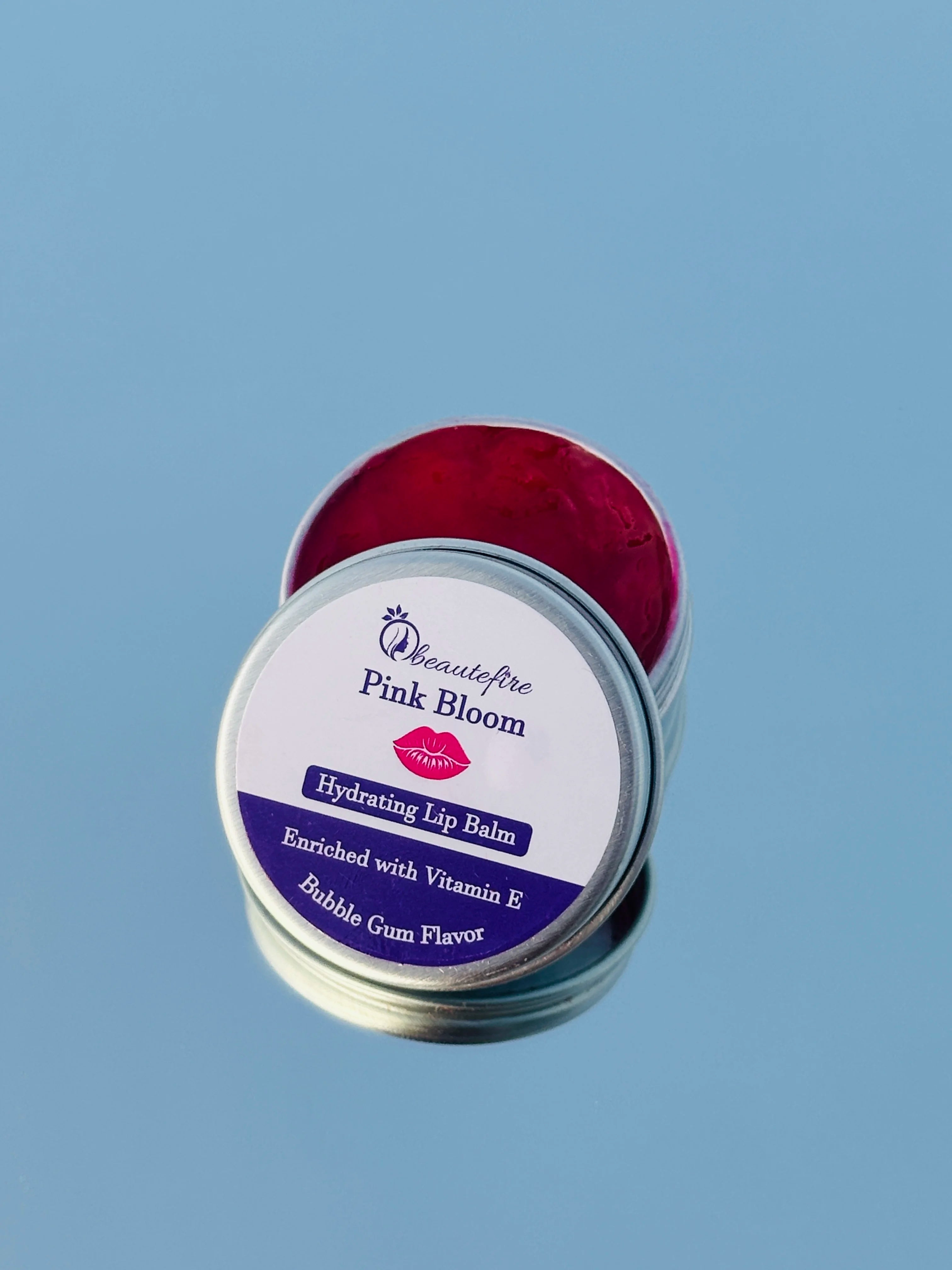 Beautefire Pink Bloom Lip Balm on mirror ā premium tinted balm reflecting soft pink glow and hydration.