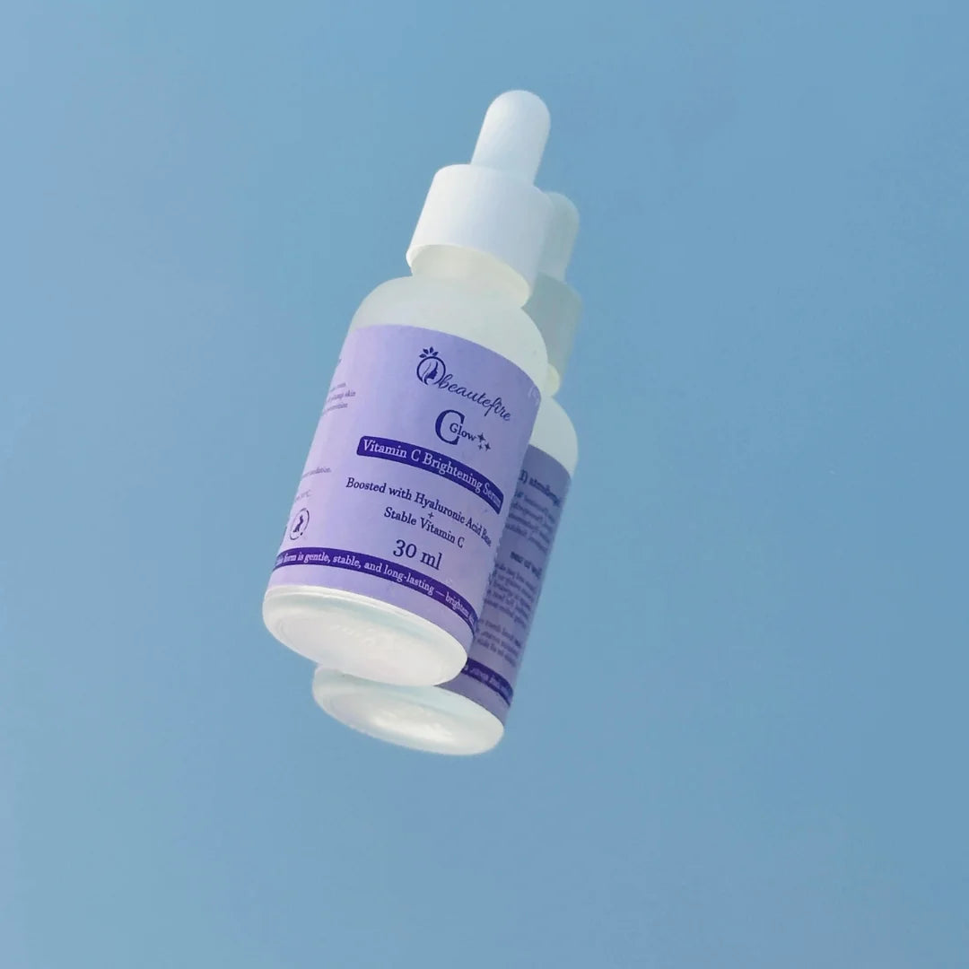 Beautefire C Glow Serum placed on light blue mirror — natural light capture of hydrating, glow-boosting Vitamin C serum.