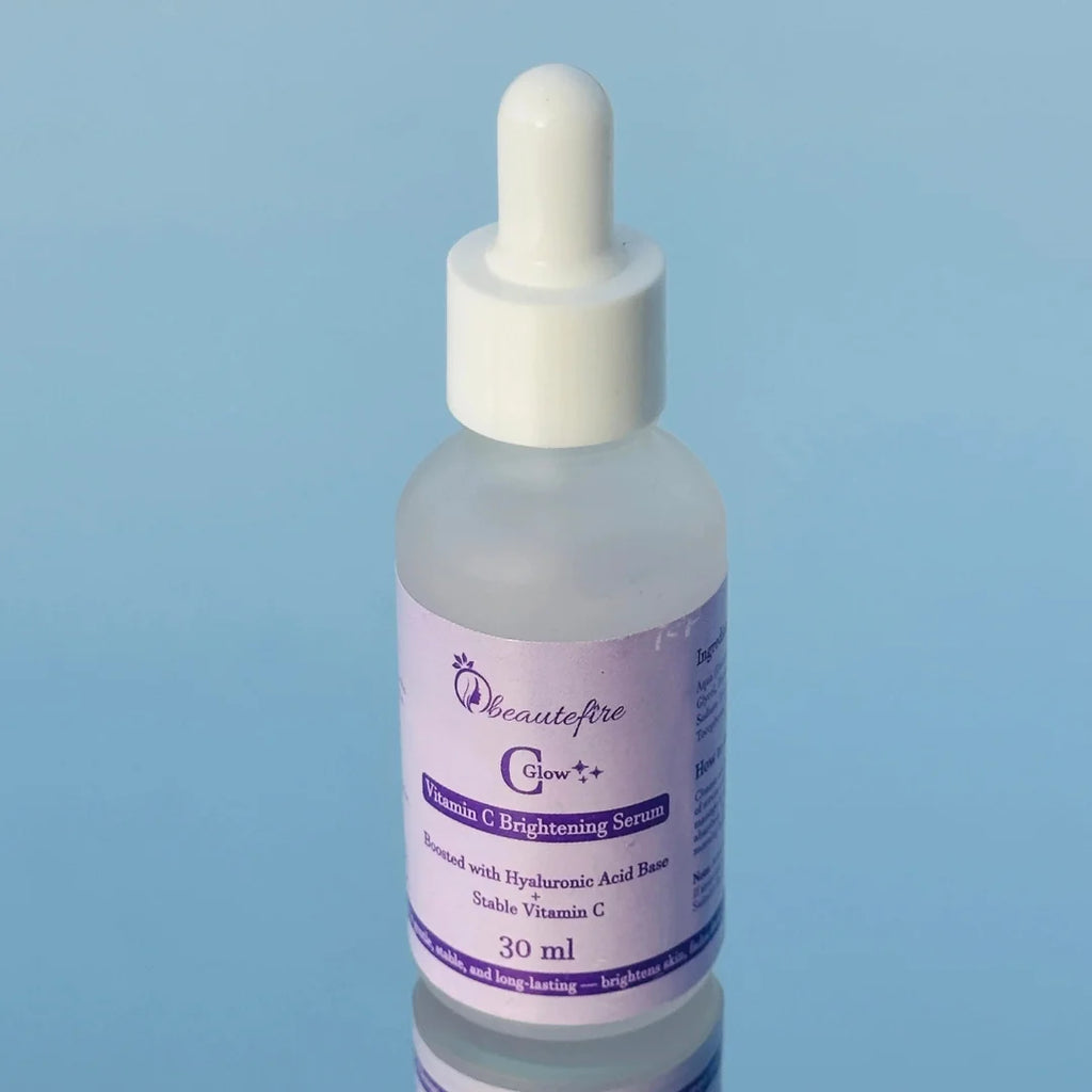 Beautefire C Glow Serum placed on light blue mirror — natural light capture of hydrating, glow-boosting Vitamin C serum.