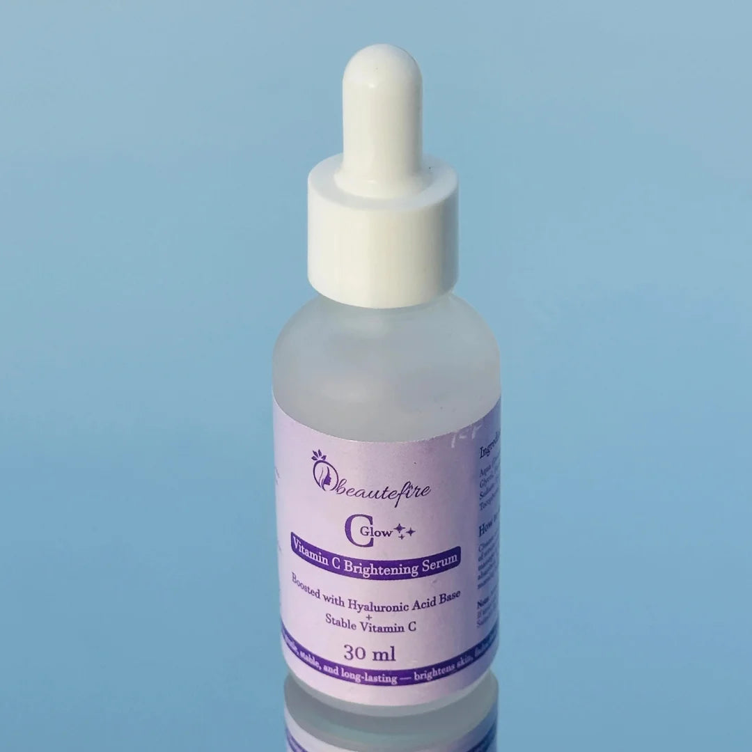Beautefire C Glow Serum placed on light blue mirror — natural light capture of hydrating, glow-boosting Vitamin C serum.
