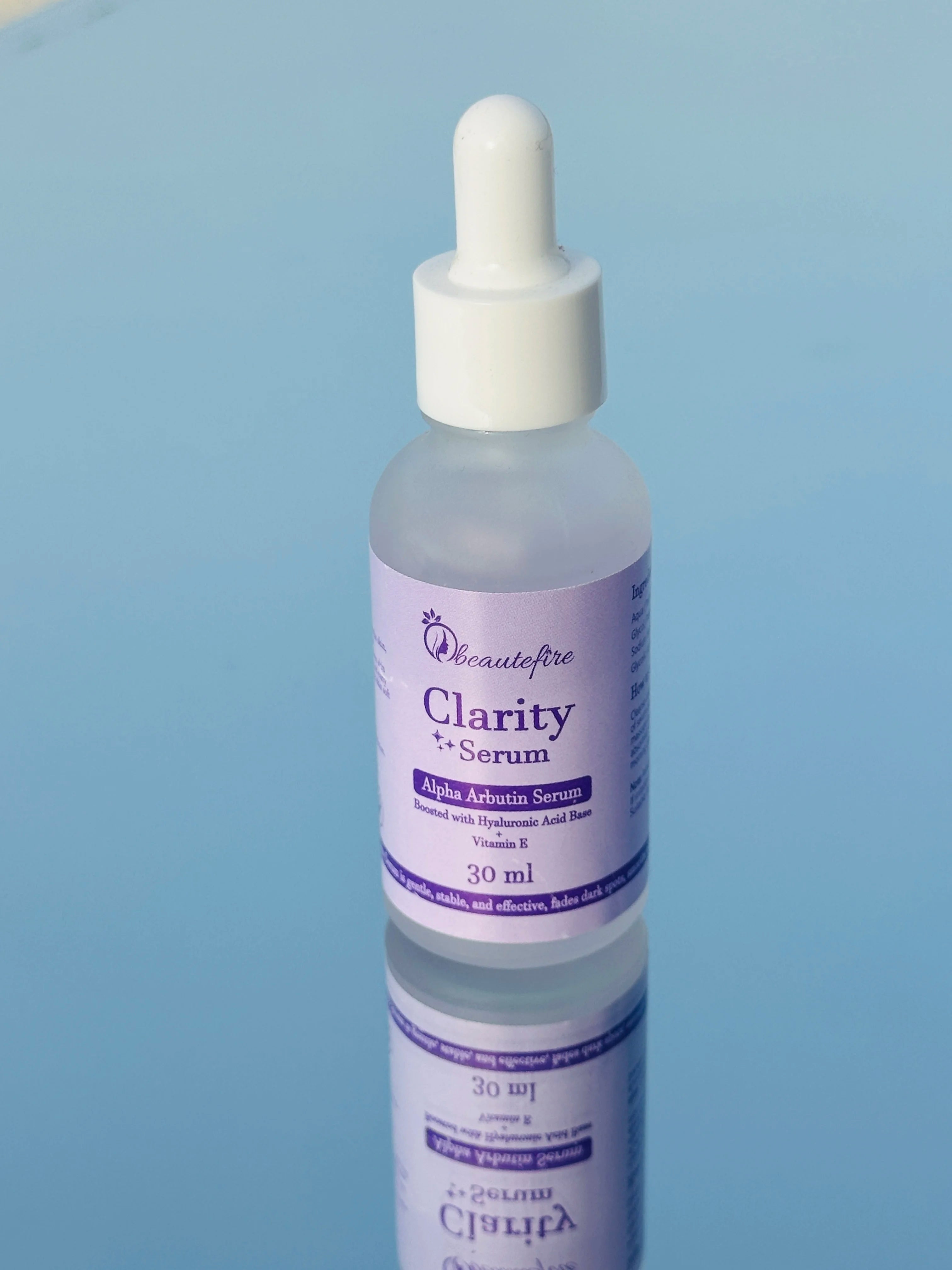 Beautefire Clarity Serum placed on mirror — luxury brightening serum with glowing, reflective aesthetic.