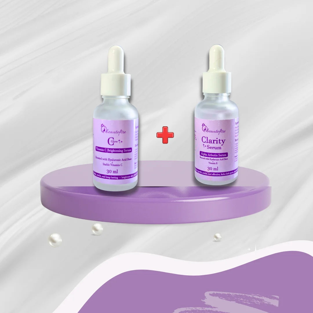 Beautéfire Clarity Alpha Arbutin Serum and Glow+ Vitamin C Brightening Serum duo displayed on a lilac stand for bright, spotless skin.