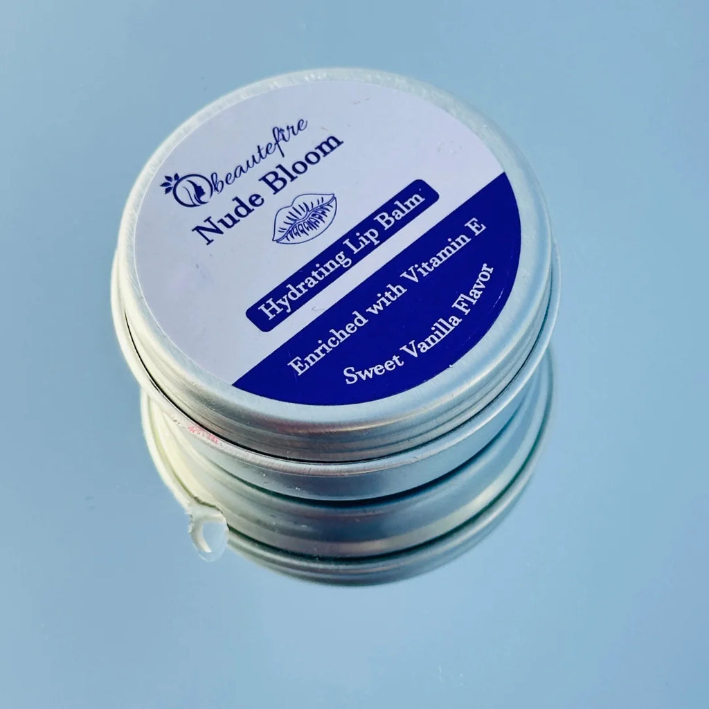 Beautefire Nude Bloom Lip Balm on sky with mirror — elegant nude-tinted balm reflecting a soft, natural glow with deep nourishment.
