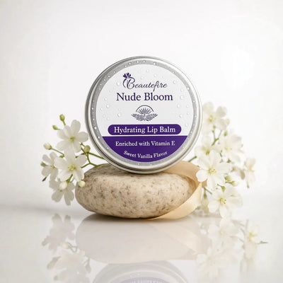 Beautefire Nude Bloom Lip Balm front view with white flowers— hydrating balm that restores natural lip tone and softness with a nude finish.