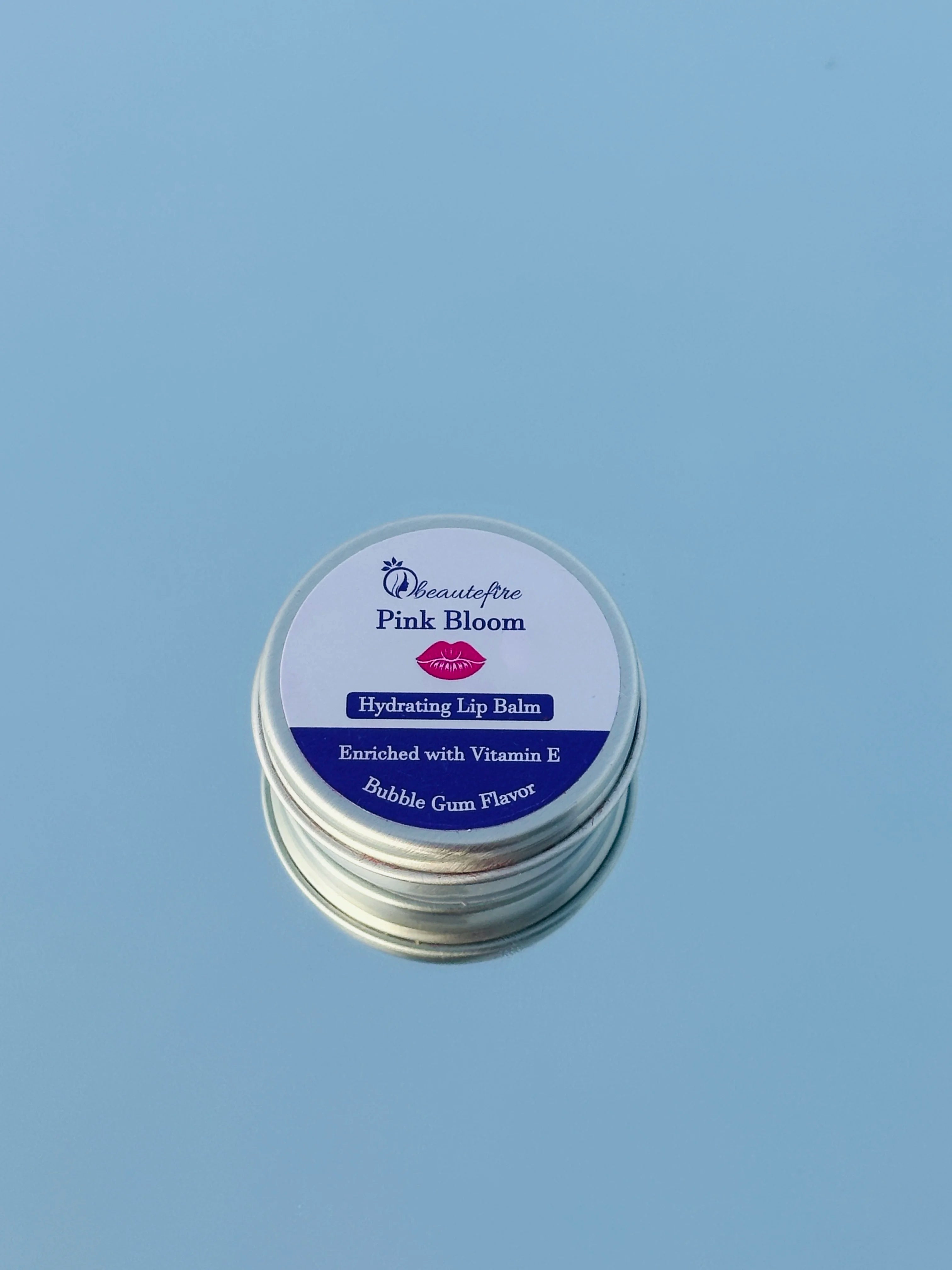 Beautefire Pink Bloom Lip Balm on mirror and sky — premium tinted balm reflecting soft pink glow and hydration.