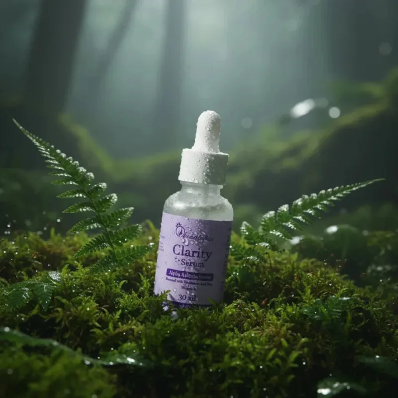 Clarity Alpha Arbutin serum bottle resting on moss among ferns